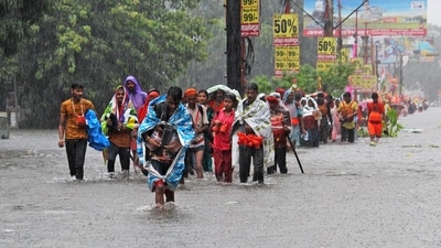 Kanwariyas, the devotees of Hindu god Shiva, carry holy water from river Ganges as they walk through a flooded street during their 'Kanwar Yatra' pilgrimage after heavy rains in Haridwar, in India's Uttarakhand state. (Photo by AFP) Kanwariyas, the devotees of Hindu god Shiva, carry holy water from river Ganges as they walk through a flooded street during their 'Kanwar Yatra' pilgrimage after heavy rains in Haridwar, in India's Uttarakhand state. (Photo by AFP)