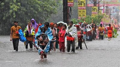 Kanwariyas walk through a flooded street following heavy rains in Haridwar, in Uttarakhand. (AFP) Kanwariyas walk through a flooded street following heavy rains in Haridwar, in Uttarakhand. (AFP)