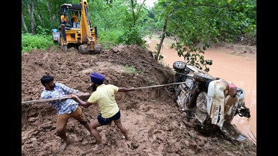 Rescue workers pulling out the car which sank in the rivulet in Mohali on Tuesday. (Ravi Kumar/HT)