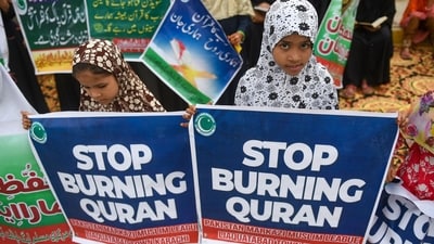 Activists and supporters of Pakistan Markazi Muslim League (PMML) party take part in an anti-Sweden demonstration in Karachi as they protest against the burning of the Koran outside a Stockholm mosque that outraged Muslims around the world. (AFP)