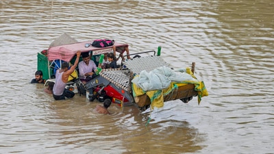 People from low-lying areas around the Yamuna river move a tractor stuck in floodwaters. Following the rise in Yamuna levels, the Delhi Police imposed section 144 CrPC in flood prone areas of the national capital on Wednesday. (PTI) People from low-lying areas around the Yamuna river move a tractor stuck in floodwaters. Following the rise in Yamuna levels, the Delhi Police imposed section 144 CrPC in flood prone areas of the national capital on Wednesday. (PTI)