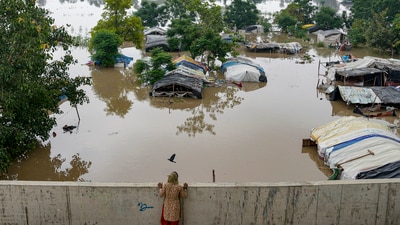 Swollen Yamuna river floods low-lying areas after heavy monsoon rain, in New Delhi, Wednesday. The low-lying flood prone areas near the river in Delhi are inhabited by around 41,000 people. (PTI) Swollen Yamuna river floods low-lying areas after heavy monsoon rain, in New Delhi, Wednesday. The low-lying flood prone areas near the river in Delhi are inhabited by around 41,000 people. (PTI)