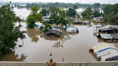 Swollen Yamuna river floods low-lying areas after heavy monsoon rain, in New Delhi, Wednesday. The low-lying flood prone areas near the river in Delhi are inhabited by around 41,000 people. (PTI) Swollen Yamuna river floods low-lying areas after heavy monsoon rain, in New Delhi, Wednesday. The low-lying flood prone areas near the river in Delhi are inhabited by around 41,000 people. (PTI)