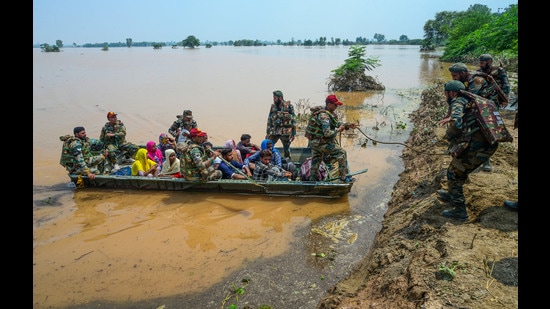 Army personnel rescue residents from a flood-affected area following monsoon rains, in Lohian area of Jalandhar district on Wednesday. (PTI)
