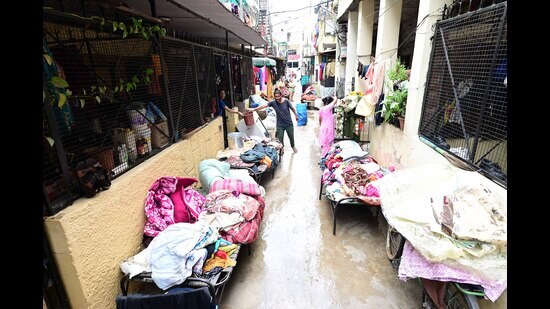 With the sun coming out for the second straight day on Wednesday, residents trying to dry their household articles that were soaked after rainwater entered their houses in Phase 11, Mohali, on Sunday. (Ravi Kumar/HT)