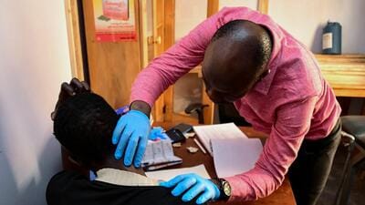 A medical clinic officer examines an unidentified transgender and LGBTQ member, who is one of their patients at the Ice Breakers Uganda (IBU) clinic in Makindye that supports HIV/AIDS programmes and treatment for the LGBTQ community in Salaama road, Kampala, Uganda. (REUTERS) A medical clinic officer examines an unidentified transgender and LGBTQ member, who is one of their patients at the Ice Breakers Uganda (IBU) clinic in Makindye that supports HIV/AIDS programmes and treatment for the LGBTQ community in Salaama road, Kampala, Uganda. (REUTERS)