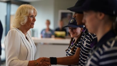 Queen Camilla, left, meets ballboy and ballgirls Larissa, Sean Michael and Cassie as she arrives for her visit on day ten of the 2023 Wimbledon Championships at the All England Lawn Tennis and Croquet Club in London. (AP) Queen Camilla, left, meets ballboy and ballgirls Larissa, Sean Michael and Cassie as she arrives for her visit on day ten of the 2023 Wimbledon Championships at the All England Lawn Tennis and Croquet Club in London. (AP)