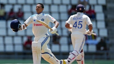 India's Yashasvi Jaiswal celebrates after he scored a century against West Indies in a partnership with captain Rohit Sharma (AP)