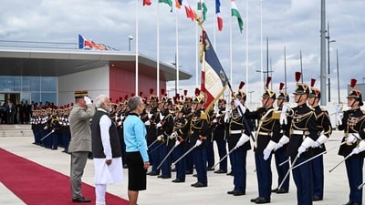 France's Prime Minister Elisabeth Borne (3L) and Prime Minister Narendra Modi (2L) stand in front of French Republican Guards at the Orly airport in Orly, Paris' suburb. (AFP) France's Prime Minister Elisabeth Borne (3L) and Prime Minister Narendra Modi (2L) stand in front of French Republican Guards at the Orly airport in Orly, Paris' suburb. (AFP)