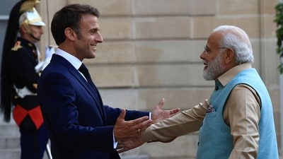 French President Emmanuel Macron welcomes Indian Prime Minister Narendra Modi before a working dinner (AP) French President Emmanuel Macron welcomes Indian Prime Minister Narendra Modi before a working dinner (AP)