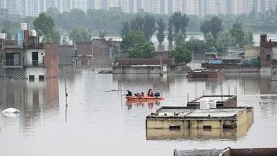 National Disaster Response Force personnel rescue people from flooded waters at Jaitpur Khadda in New Delhi on Thursday. (Sunil Ghosh/HT Photo) National Disaster Response Force personnel rescue people from flooded waters at Jaitpur Khadda in New Delhi on Thursday. (Sunil Ghosh/HT Photo)