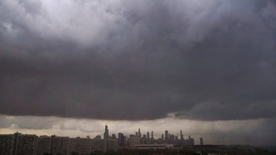 Chicago Weather: Storm clouds pass over downtown Chicago and the Bronzeville neighborhood of the city. (AP)