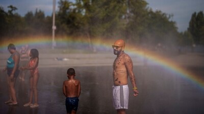 People cool off at an urban beach of Madrid Rio park in Madrid, Spain. More than 10 of Spain's regions are on red alert for the second day of the latest heat wave, with temperatures topping 40 degrees Celsius (AP Photo/Manu Fernandez) People cool off at an urban beach of Madrid Rio park in Madrid, Spain. More than 10 of Spain's regions are on red alert for the second day of the latest heat wave, with temperatures topping 40 degrees Celsius (AP Photo/Manu Fernandez)