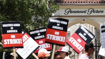 Striking WGA (Writers Guild of America) workers picket outside Paramount Studios on July 12, 2023 in Los Angeles, California. (Getty Images via AFP) Striking WGA (Writers Guild of America) workers picket outside Paramount Studios on July 12, 2023 in Los Angeles, California. (Getty Images via AFP)