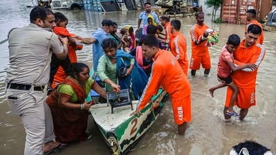 NDRF (National Disaster Response Force) personnel rescue a baby along with other people from low-lying areas around the Yamuna river. near Mayur Vihar Side in New Delhi, India, on Wednesday. (Photo by Raj K Raj/ Hindustan Times) NDRF (National Disaster Response Force) personnel rescue a baby along with other people from low-lying areas around the Yamuna river. near Mayur Vihar Side in New Delhi, India, on Wednesday. (Photo by Raj K Raj/ Hindustan Times)