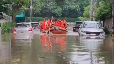 NDRF personnel used boats to rescue a family from a flooded bungalow in Civil Lines. NDRF personnel used boats to rescue a family from a flooded bungalow in Civil Lines.