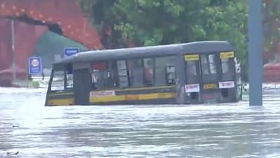 A police van seen stuck in a waterlogged road in Delhi. (ANI)