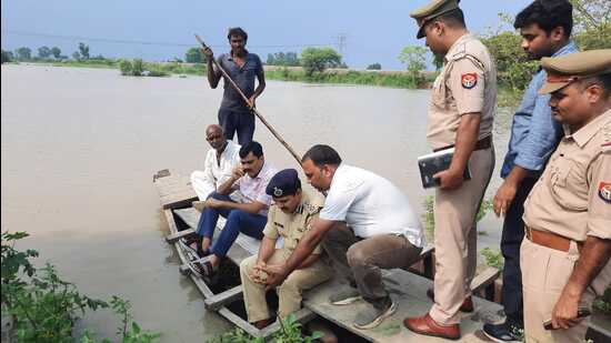 Aligarh DM Indra Vikram Singh and SSP Kalanidhi Naithani on boat in Maharajgarh village of Aligarh on Thursday. (HT photo)