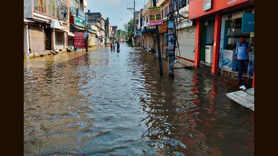 The residential colonies along the Buddha Nullah remains flooded in Ludhiana on Thursday; and (right) a big road cave-in on the ATI Road. (Gurpreet Singh/HT)