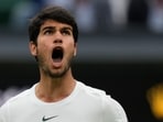 Spain's Carlos Alcaraz reacts after winning a point against Russia's Daniil Medvedev in a men's singles semifinal match on day twelve of the Wimbledon tennis championships