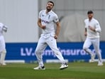 England's Mark Wood (C) celebrates