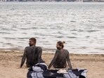 A couple covered in mud that is believed to be curative sit at the Queen's beach in Croatia. (Reuters)