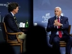 Republican presidential candidate former Vice President Mike Pence talks with moderator Tucker Carlson, left, during the Family Leadership Summit, Friday, July 14, 2023, in Des Moines, Iowa. (AP Photo/Charlie Neibergall)