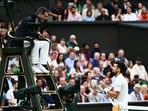 Serbia's Novak Djokovic (L) argues with the umpire following a point deduction for shouting as he plays against to Italy's Jannik Sinner during their men's singles semi-finals tennis match
