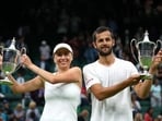 Croatia’s Mate Pavic and Ukraine’s Lyudmyla Kichenok celebrate with their trophies after winning their mixed doubles final match against Belgium’s Joran Vliegen and China’s Yifan Xu