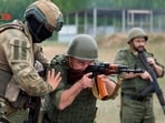 A fighter from Russian Wagner mercenary group conducts training for Belarusian soldiers on a range near the town of Osipovichi, Belarus July 14 in this still image taken from handout video.