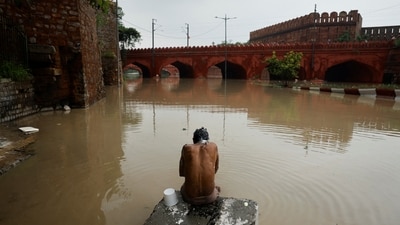 A man takes a bath behind the Red Fort after the waters of the Yamuna River flooded low-lying areas in the national capital. (REUTERS)