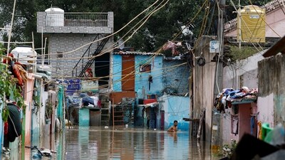 A man walks in a flooded alley as Yamuna River water enters low-lying areas following the release of water from the Hathi Kund barrage in Haryana. (Reuters)