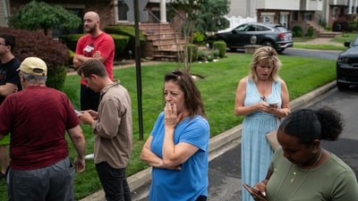 Residents try to take a look as police officers search the house where a suspect has been taken into custody on New York's Long Island in connection with a long-unsolved string of killings, known as the Gilgo Beach murders, Friday, July 14, 2023, in Massapequa Park, N.Y. (AP Photo/Eduardo Munoz Alvarez) (AP) Residents try to take a look as police officers search the house where a suspect has been taken into custody on New York's Long Island in connection with a long-unsolved string of killings, known as the Gilgo Beach murders, Friday, July 14, 2023, in Massapequa Park, N.Y. (AP Photo/Eduardo Munoz Alvarez) (AP)