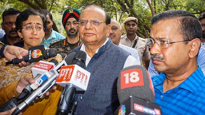 Delhi Lt Governor VK Saxena and CM Arvind Kejriwal speak to the media after inspecting the damaged drain regulator at Vikas Marg, ITO, in New Delhi on Friday, (PTI) Delhi Lt Governor VK Saxena and CM Arvind Kejriwal speak to the media after inspecting the damaged drain regulator at Vikas Marg, ITO, in New Delhi on Friday, (PTI)