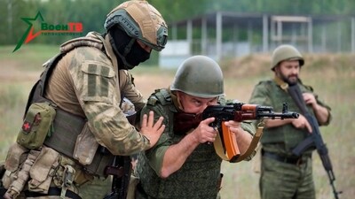 A fighter from Russian Wagner mercenary group conducts training for Belarusian soldiers on a range near the town of Osipovichi, Belarus July 14 in this still image taken from handout video. (via REUTERS)