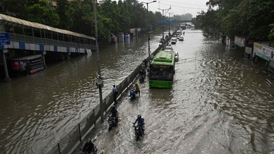 Vehicles ride through a flooded street after Yamuna river overflowed due to monsoon rains in New Delhi on Friday. (AFP) Vehicles ride through a flooded street after Yamuna river overflowed due to monsoon rains in New Delhi on Friday. (AFP)