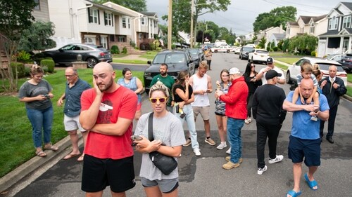 Residents try to take a look as police officers search the house where a suspect has been taken into custody on New York's Long Island in connection with a long-unsolved string of killings, known as the Gilgo Beach murders, Friday, July 14, 2023, in Massapequa Park, N.Y. (AP Photo/Eduardo Munoz Alvarez) (AP) Residents try to take a look as police officers search the house where a suspect has been taken into custody on New York's Long Island in connection with a long-unsolved string of killings, known as the Gilgo Beach murders, Friday, July 14, 2023, in Massapequa Park, N.Y. (AP Photo/Eduardo Munoz Alvarez) (AP)