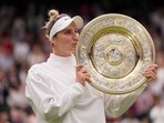Czech Republic's Marketa Vondrousova celebrates with the trophy after beating Tunisia's Ons Jabeur to win the final of the women's singles on day thirteen of the Wimbledon tennis championships