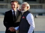 French President Emmanuel Macron and Prime Minister Narendra Modi shake hands.