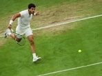 Spain's Carlos Alcaraz returns the ball to Russia's Daniil Medvedev during their men's singles semi-finals tennis match on the twelfth day of the 2023 Wimbledon Championships at The All England Lawn Tennis Club in Wimbledon