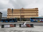 A woman uses her mobile phone in front of the Federal Security Service (FSB) building on Lubyanka Square in Moscow, Russia