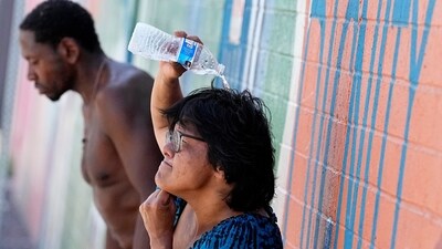 People, who are homeless, try to cool down with chilled water outside the Justa Center, a day center for homeless people 55 years and older, Friday, July 14, 2023, in downtown Phoenix. Phoenix marked the city’s 15th consecutive day of 110 degrees Fahrenheit (43.3 degrees Celsius) or higher temperatures on Friday. (AP Photo/Matt York) (AP) People, who are homeless, try to cool down with chilled water outside the Justa Center, a day center for homeless people 55 years and older, Friday, July 14, 2023, in downtown Phoenix. Phoenix marked the city’s 15th consecutive day of 110 degrees Fahrenheit (43.3 degrees Celsius) or higher temperatures on Friday. (AP Photo/Matt York) (AP)