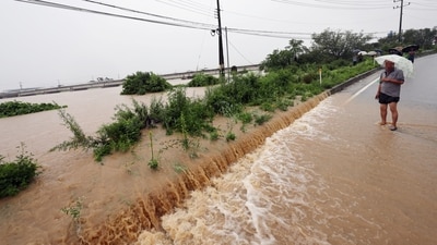 A view of a road submerged by a flooded river caused by heavy rain in Cheongju, South Korea on Friday. (via REUTERS)