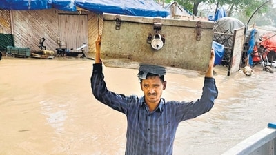 Khushiyal Kumar, a vegetable farmer, ventured back home with a private diver, swimming around two kilometres, only to get a trunk filled with some documents, clothes and a Solar panel. (HT PHOTO) Khushiyal Kumar, a vegetable farmer, ventured back home with a private diver, swimming around two kilometres, only to get a trunk filled with some documents, clothes and a Solar panel. (HT PHOTO)