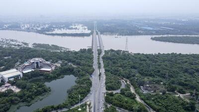 Swathes of land are seen inundated with water from the swollen river Yamuna in New Delhi on Saturday. (AP) Swathes of land are seen inundated with water from the swollen river Yamuna in New Delhi on Saturday. (AP)