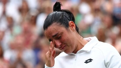 Tunisia’s Ons Jabeur with the runners up trophy reacts after losing her final match against Czech Republic's Marketa Vondrousova (REUTERS)