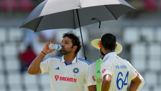India's captain Rohit Sharma and teammate Yashasvi Jaiswal refresh during a drinks break (AP)