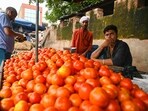 People buying the tomato in a vegetable market
