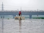 Delhi Metro train passes above Yamuna river after heavy monsoon rains, in New Delhi, Monday. (PTI)
