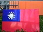 A worker holds Taiwan's flag. A worker holds Taiwan's flag.